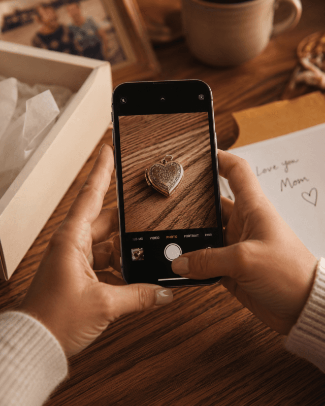 Close-Up Of Hands Photographing A Sentimental Keepsake, Part Of How To Use Ai To Declutter Before A Move Without Losing The Memories That Matter