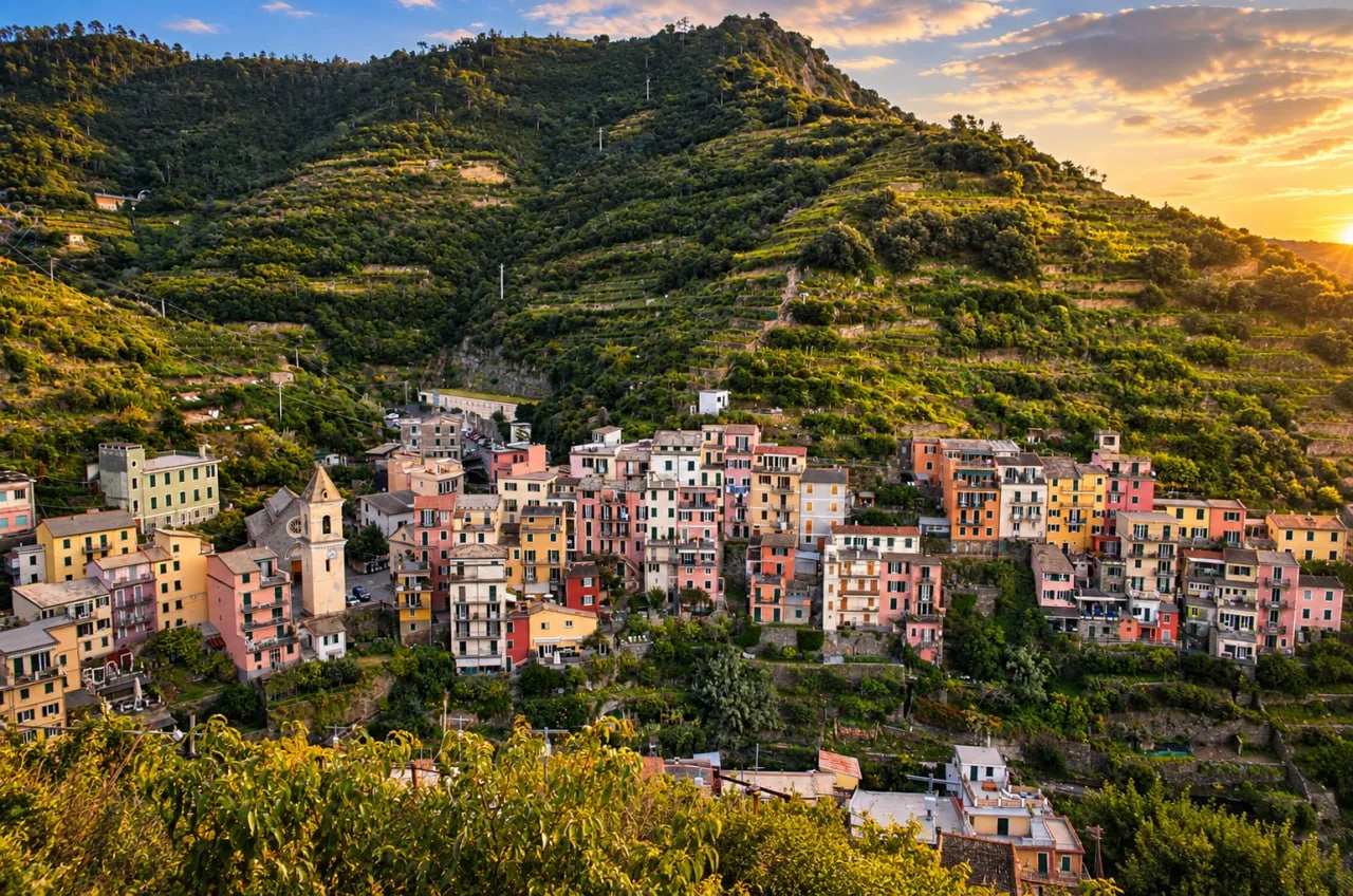 Cinque Terre Village Panorama J Photo Pastel Hillside Buildings And A Church Tower Catch Warm Light Beneath Green Terraces And A Glowing Sky.