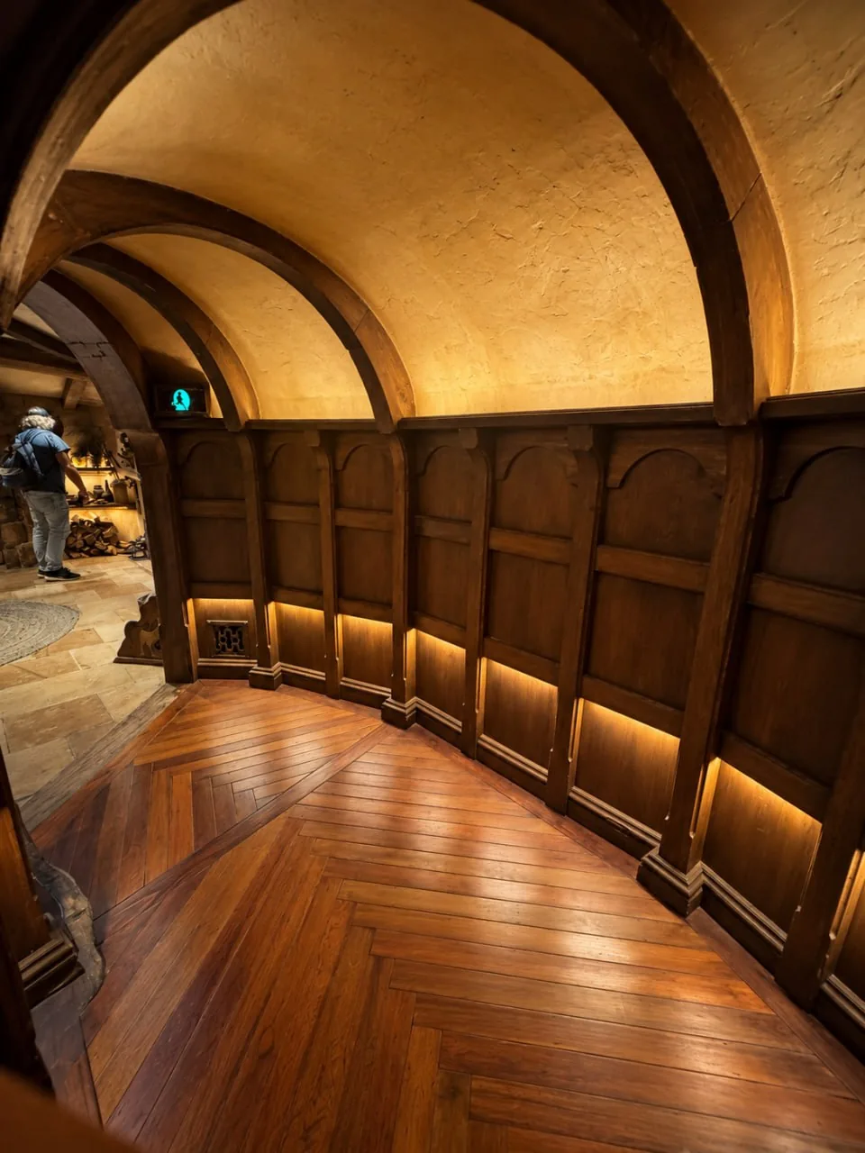 A Curved Wooden Hallway With A Series Of Rounded Arches.
